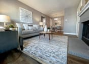 Thumbnail 17 of 38 - an open living room with a fireplace and a rug