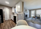 Thumbnail 12 of 38 - an open kitchen and living room with a table and chairs