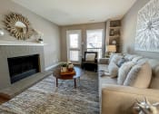 Thumbnail 6 of 38 - an open living room with a fireplace and a couch