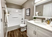 Thumbnail 7 of 38 - a bathroom with a sink toilet and a bath tub