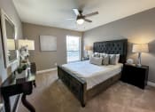 Thumbnail 5 of 38 - a bedroom with a large bed and a ceiling fan