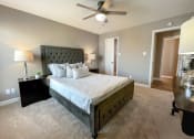 Thumbnail 3 of 38 - a bedroom with a large bed and a ceiling fan