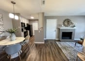 Thumbnail 2 of 38 - an open living room and dining room with a fireplace and a table
