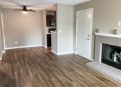 Thumbnail 21 of 38 - a living room with wood floors and a fireplace
