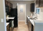 Thumbnail 19 of 38 - a kitchen with black appliances and a black refrigerator