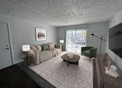 Thumbnail 6 of 18 - A living room with a grey couch, a green armchair, and a coffee table.