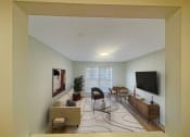 Thumbnail 8 of 31 - a living room with a couch and a table and a television at The Courts Midtown, Tennessee
