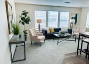 Thumbnail 9 of 65 - a living room with a couch and chairs and a table