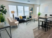 Thumbnail 3 of 65 - a living room with a couch and chairs and a table