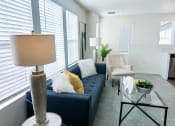 Thumbnail 6 of 65 - a living room with a blue couch and a glass coffee table