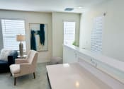 Thumbnail 34 of 65 - a living room with white furniture and a white counter top