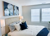 Thumbnail 23 of 65 - a bedroom with a large bed and two windows with blinds
