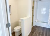 Thumbnail 56 of 65 - a bathroom with a toilet and a tub and a shower