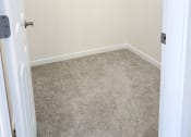 Thumbnail 41 of 65 - an empty closet in a bathroom with a carpeted floor and white walls