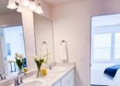 Thumbnail 28 of 65 - a white bathroom with two sinks and a mirror