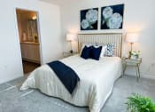 Thumbnail 11 of 65 - a bedroom with a white bed and two paintings on the wall