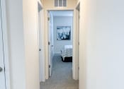 Thumbnail 36 of 65 - an empty hallway with a bed in the end of the room
