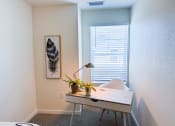 Thumbnail 32 of 65 - a home office with a desk and a window