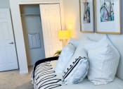 Thumbnail 45 of 65 - a bedroom with a bed and two pictures on the wall