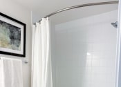 Thumbnail 59 of 65 - a bathroom with a toilet and a bath tub