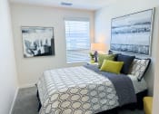Thumbnail 15 of 65 - a bedroom with a bed and pictures on the wall