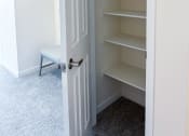 Thumbnail 50 of 65 - a small closet with shelves and a white door