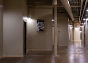 Thumbnail 15 of 17 - A long hallway with a black and white picture on the wall.
