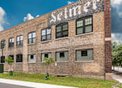 Thumbnail 1 of 17 - A brick building with the word "Seimer" on it.