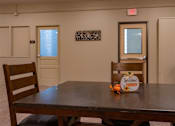 Thumbnail 13 of 17 - A wooden table with a sign that says "Welcome Friends" on it.