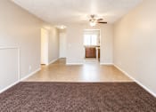Thumbnail 5 of 7 - A room with a brown carpet and a ceiling fan.