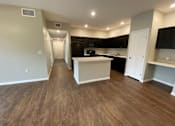 Thumbnail 15 of 23 - A kitchen with a white island in the middle of the room.