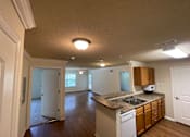 Thumbnail 3 of 15 - A kitchen with a sink, counter, and cabinets.