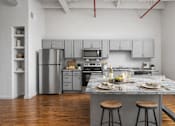 Thumbnail 11 of 16 - A kitchen with a white stove and white oven.
