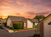Thumbnail 24 of 33 - A row of houses with a sunset in the background.