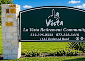 Thumbnail 32 of 33 - A sign for La Vista Retirement Community with a phone number and address.