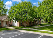 Thumbnail 28 of 33 - A row of houses with trees in front of them.