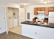 Thumbnail 20 of 20 - A kitchen with white cabinets and a black countertop.