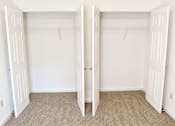 Thumbnail 14 of 20 - A room with two open white closets.