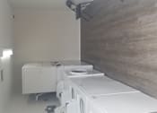 Thumbnail 9 of 16 - A row of washing machines in a laundromat.