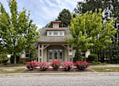 Thumbnail 2 of 5 - the front of a house with flowers in front of it