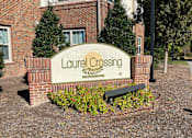 Thumbnail 1 of 5 - the sign in front of the leasing office of laurel crossing apartments