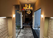 Thumbnail 2 of 43 - A hallway with a chandelier and a Starbucks sign on the wall.