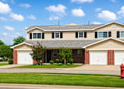 Thumbnail 6 of 14 - A house with a red fire hydrant in front of it.