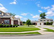 Thumbnail 5 of 14 - A suburban neighborhood with houses and a clear sky.
