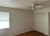Thumbnail 5 of 8 - a bedroom with a ceiling fan and a closet
