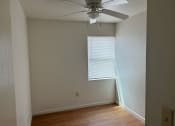 Thumbnail 4 of 8 - an empty room with a ceiling fan and a window