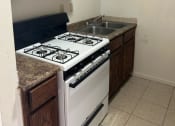 Thumbnail 6 of 8 - a kitchen with a stove and a sink
