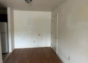 Thumbnail 8 of 8 - an empty room with white walls and a refrigerator