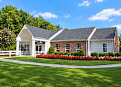 Thumbnail 3 of 37 - A white house with a red brick chimney and a white fence.