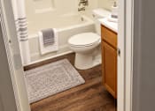 Thumbnail 24 of 37 - A white toilet is in a bathroom with a white shower curtain.